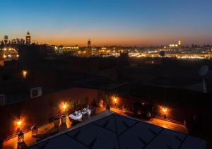 a view of a city at night with lights at Riad Des Nations in Marrakesh