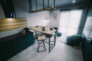 a kitchen with a wooden table in a room at Kostjukowski brand-new apart-hotel in Lviv