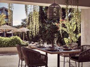 a table and chairs in a patio with a table and chairsktop at Contessina Hotel in Tsilivi