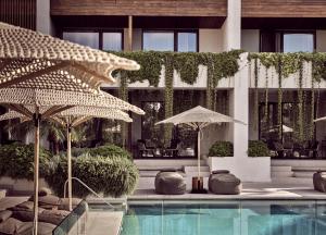 a swimming pool with umbrellas in a building at Contessina Hotel in Tsilivi
