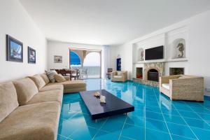 a living room with a blue tile floor at Villa Buon Gesu' in Massa Lubrense