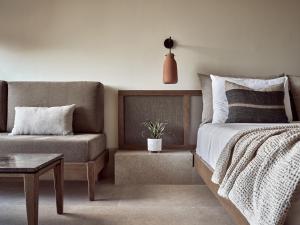 a bedroom with a bed and a couch at Contessina Hotel in Tsilivi
