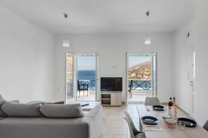 a living room with a couch and a table at Waterview Apartments in Kini