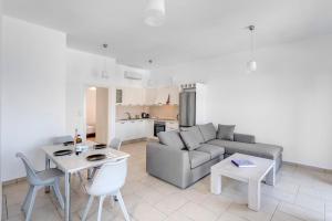 a living room with a couch and a table at Waterview Apartments in Kini