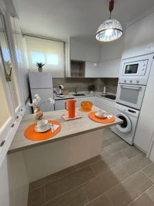 a kitchen with a counter with two plates on it at Apartamento Entrebateas in Aldán