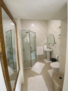 a bathroom with a shower and a toilet and a sink at SOUTH HILL VILLA in Mahe +115 photos