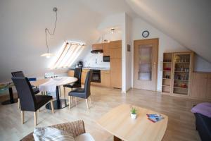 a living room with a table and chairs and a kitchen at Das Loft Hotel Willingen in Willingen