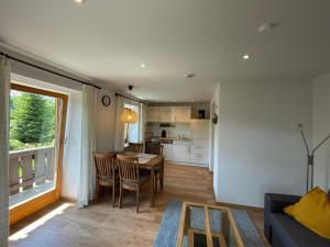 a kitchen and living room with a table and chairs at Haus Belvedere in Berchtesgaden