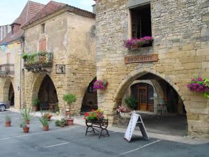 a stone building with a sign in front of it at emplacement camping in Montcléra