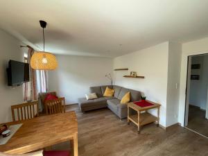 a living room with a couch and a table at Haus Belvedere in Berchtesgaden