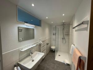 a bathroom with a sink and a shower at Haus Belvedere in Berchtesgaden +35 photos