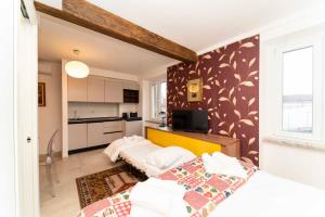 a bedroom with two beds and a kitchen at Castello Central & Panoramic Studio in Turin