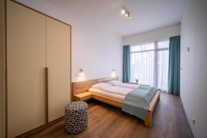 En eller flere senger på et rom på Lipno Port Apartment C303 - Lipno Home