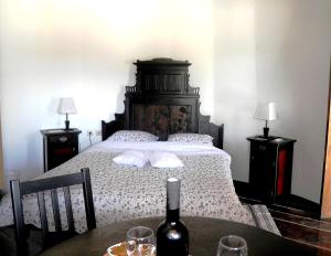 a bedroom with a bed with a bottle of wine on a table at Agroturizam Duvančić - Konoba dida Marka in Drniš