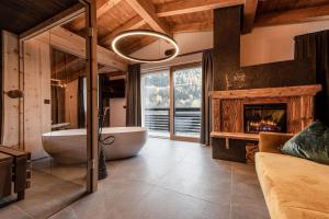 a large bathroom with a tub and a fireplace at Nidaris - Luxury Private Spa Suites in Malè