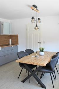 uma sala de jantar com uma mesa de madeira e cadeiras em Tant Berta´s Huus em Krummhörn