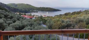 a view of a body of water from a balcony at Skalopati Studios & Villa in Panormos Skopelos
