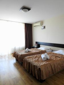 a hotel room with two beds with towels on them at Pensiunea Eric in Iaşi +72 photos