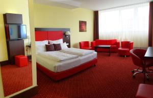 a hotel room with a bed and a television at Best Western Plus Amedia Art Salzburg in Salzburg