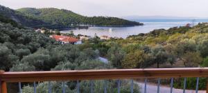 a view of a lake from a balcony at Skalopati Studios & Villa in Panormos Skopelos