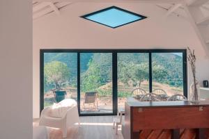 a room with a large window and a table and chairs at Casa do Losango - the Douro river as a border in Coleja