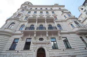 a tall white building with a clock on it at K+T Boardinghouse in Vienna