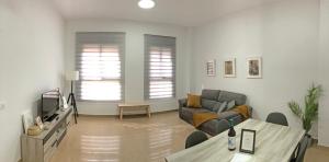 a living room with a couch and a table at Natura Apartments in Chelva