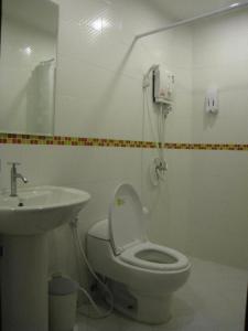 a bathroom with a toilet and a sink at Coco Nori @ Sea Resort in Klong Muang Beach