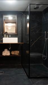 a bathroom with a shower and a sink and a mirror at Ofek's place - NOGA in Tel Aviv