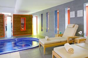 a wellness room with a plunge pool in the middle of the room at Radisson Blu Hotel Toulouse Airport in Blagnac