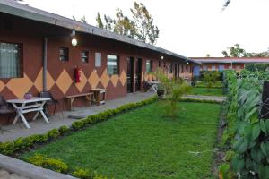 a courtyard of a building with a grass yard at Sweet Lake Resort in Naivasha