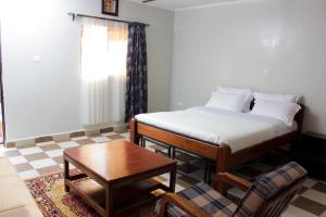 a small room with a bed and a table at Sweet Lake Resort in Naivasha