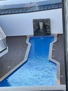 a swimming pool in the middle of a building at Salinas House T3 in Tavira