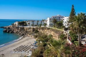 a view of a beach with buildings and the ocean at LAS VISTAS 2C MENYBER in Nerja