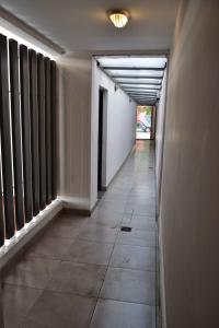 an empty hallway with windows and a long corridor at Departamento Oroño in Rosario