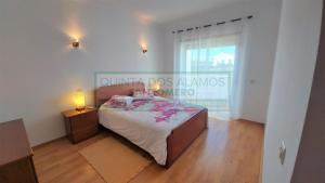 a bedroom with a bed and a large window at Apartamento AH in Guia