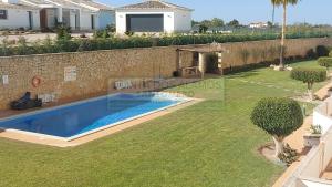 a villa with a swimming pool and a garden at Apartamento AH in Guia