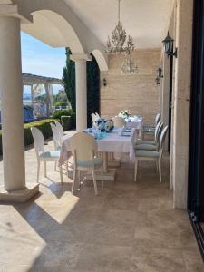 a dining table and chairs on a patio at Casa Real in Sveti Vlas