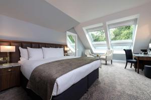 
a bedroom with a large bed and a large window at Ness Walk in Inverness
