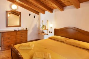 a bedroom with a large bed and a mirror at Chalet Maffins 2 in Livigno