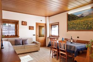 a living room with a couch and a table at Chalet Maffins 2 in Livigno