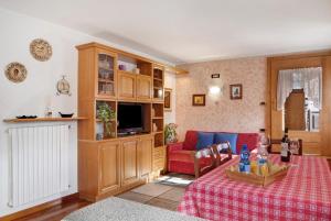 a living room with a couch and a table at Chalet Maffins 1 in Livigno