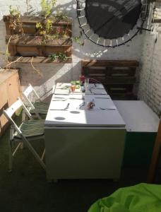 a white table and a chair in a yard at Compact, central apartment, dog friendly. in Kingsbridge
