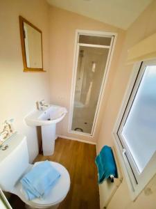 a bathroom with a white toilet and a sink at 707 Seawick in Jaywick Sands