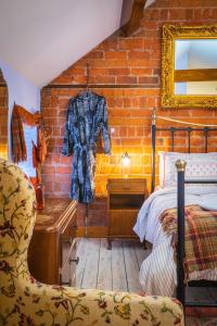 a bedroom with a bed and a brick wall at Sorley Boys Snug in Derry Londonderry