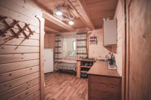 a kitchen with wooden floors and a counter top at Старий Млин in Beloberëzka +47 photos