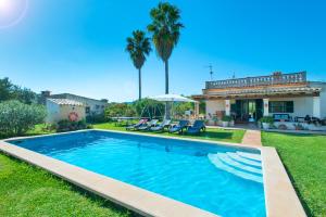 a swimming pool in the yard of a house at Owl Booking Villa Punta Magdalena - Family Holidays in Pollença