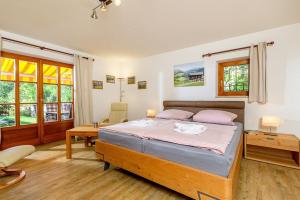 a bedroom with a bed and a table and a chair at Ferienhaus Thimlefi in Reit im Winkl