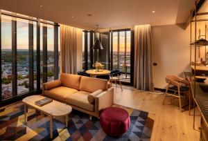 a living room with a couch and a table at Hotel Indigo Adelaide Markets by IHG in Adelaide