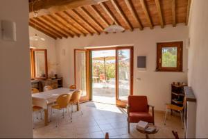 a living room with a table and chairs and an open door at Villa Aia in Lacona